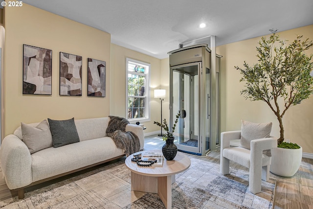 2672 SE Vista Way, Gresham, OR 97080 - living area with light wood-style flooring, baseboards, and a textured ceiling