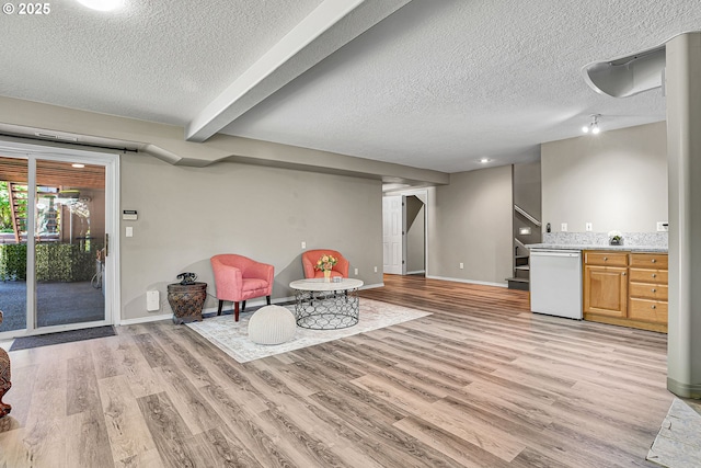 2672 SE Vista Way, Gresham, OR 97080 - living area featuring stairway, light wood-style floors, a textured ceiling, baseboards, and beam ceiling