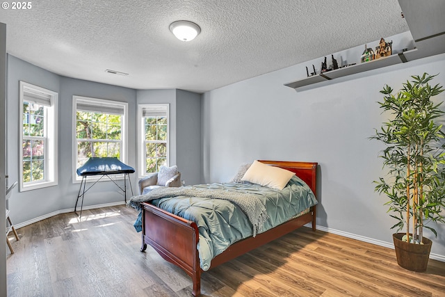 2672 SE Vista Way, Gresham, OR 97080 - bedroom with wood finished floors, baseboards, and a textured ceiling