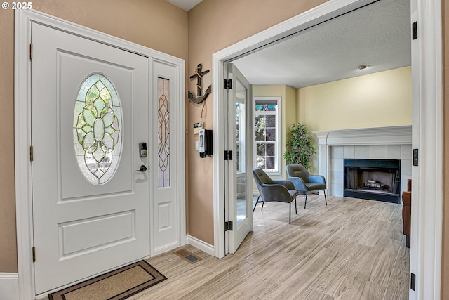 2672 SE Vista Way, Gresham, OR 97080 - entrance foyer featuring light wood-style flooring, healthy amount of natural light, a fireplace, and baseboards