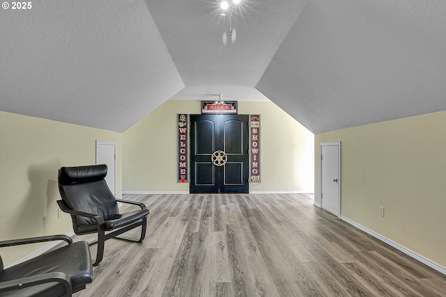 2672 SE Vista Way, Gresham, OR 97080 - living area with a textured ceiling, wood finished floors, lofted ceiling, and baseboards