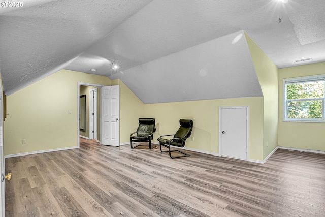 2672 SE Vista Way, Gresham, OR 97080 - unfurnished room featuring wood finished floors, a textured ceiling, vaulted ceiling, and baseboards