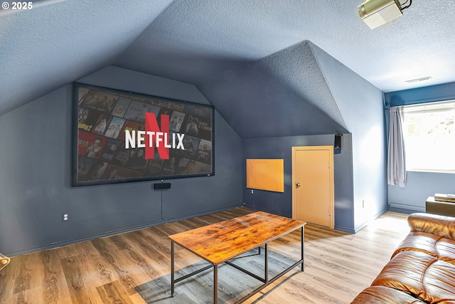2672 SE Vista Way, Gresham, OR 97080 - home theater featuring a textured ceiling, wood finished floors, baseboards, and lofted ceiling