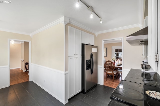 kitchen featuring white cabinets, stainless steel fridge, ornamental molding, and extractor fan