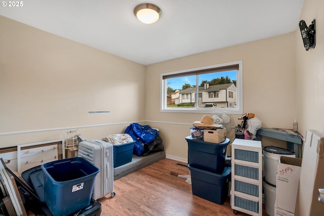 bedroom featuring wood finished floors and baseboards