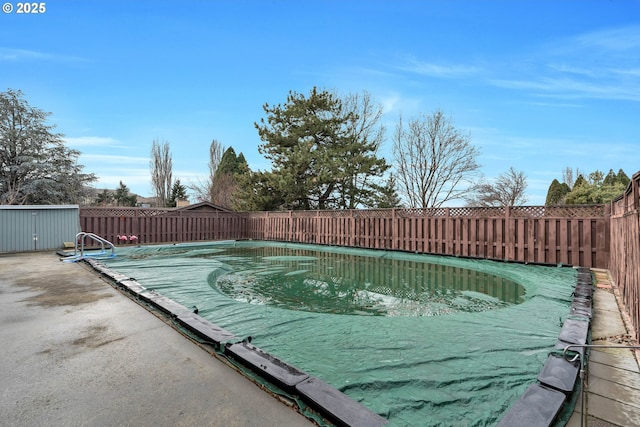 view of pool featuring a fenced in pool, a fenced backyard, and a patio