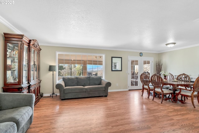 living room featuring a textured ceiling, french doors, wood finished floors, and crown molding