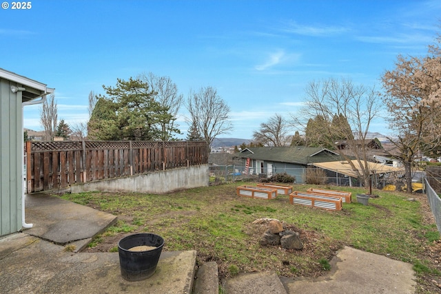 view of yard with a fenced backyard and a vegetable garden