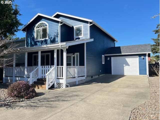 traditional home featuring an attached garage, covered porch, and concrete driveway