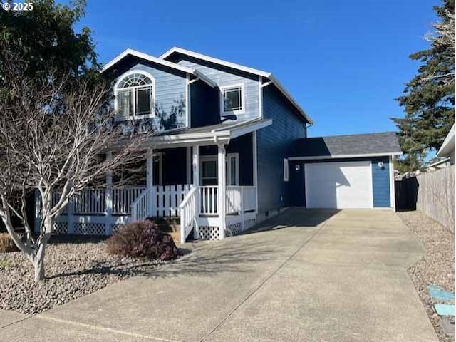 view of front of house featuring driveway, an attached garage, fence, and a porch