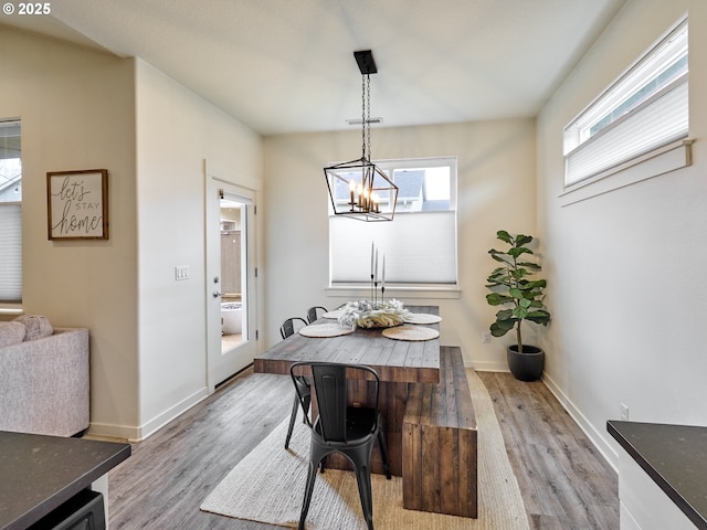 dining space with a chandelier and light hardwood / wood-style floors