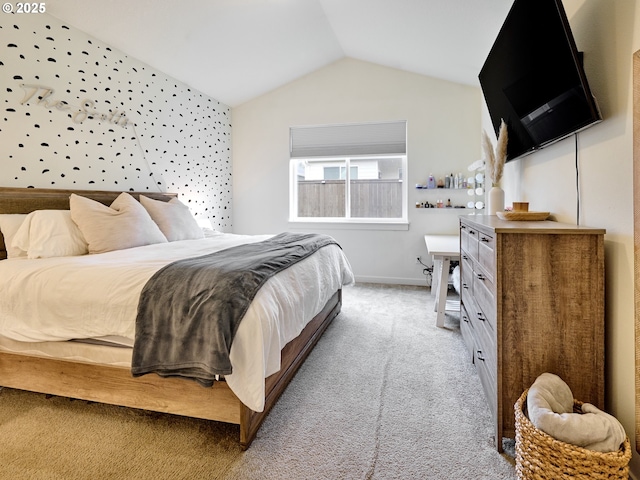 bedroom with lofted ceiling, carpet floors, and baseboards