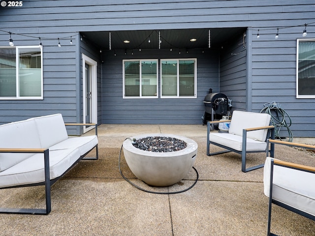 view of patio / terrace with grilling area and an outdoor living space with a fire pit