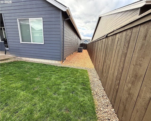 view of side of home with central AC