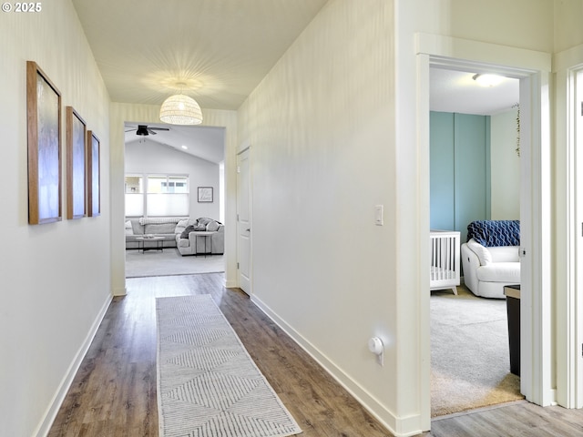 corridor with hardwood / wood-style flooring