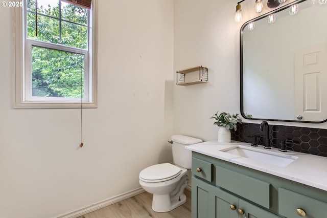 10372 NW Forestview Way, Portland, OR 97229 - bathroom featuring vanity, toilet, tasteful backsplash, wood finished floors, and baseboards
