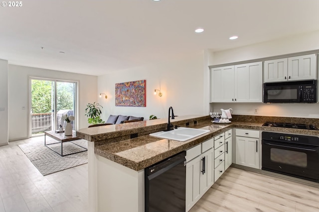 10372 NW Forestview Way, Portland, OR 97229 - kitchen with black appliances, a sink, a peninsula, light wood finished floors, and recessed lighting