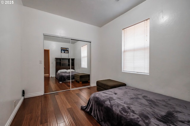 bedroom with a closet and dark hardwood / wood-style floors