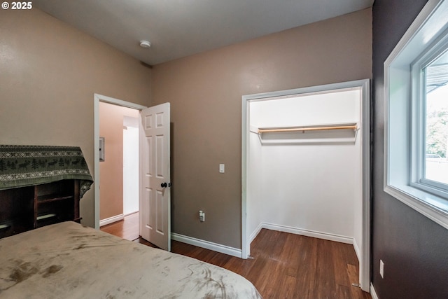 bedroom featuring a closet and dark hardwood / wood-style floors