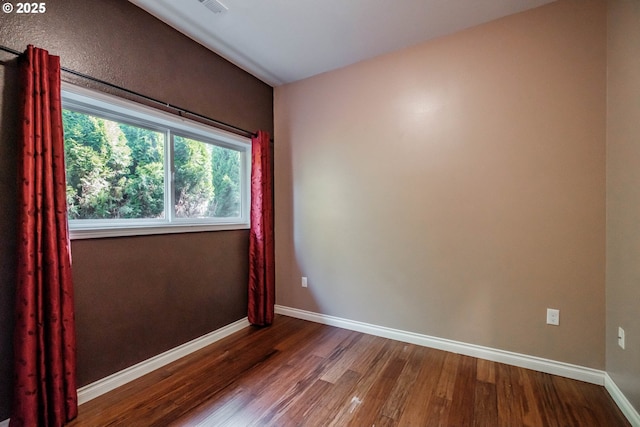 unfurnished room with hardwood / wood-style floors