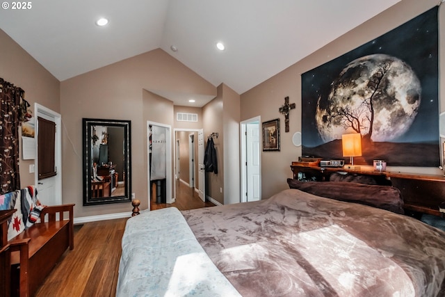 bedroom with lofted ceiling and wood-type flooring