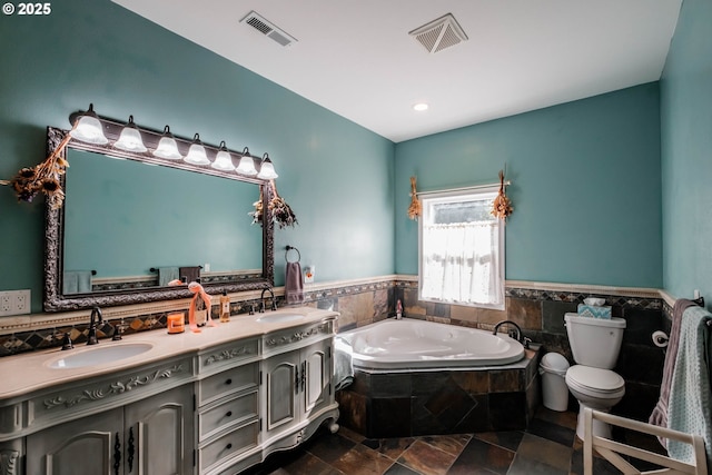 bathroom with vanity, a bathtub, and tile walls