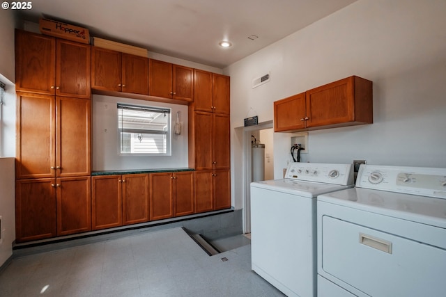 washroom with cabinets and washer and dryer