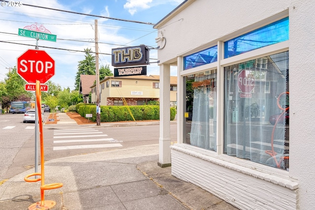2021 SE Clinton St Unit 103, Portland, OR 97202 - view of asphalt road featuring traffic signs, sidewalks, and curbs