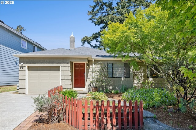 view of front of house featuring an attached garage, asphalt driveway, and a chimney