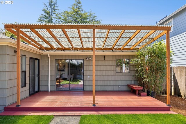 wooden deck featuring fence and a pergola