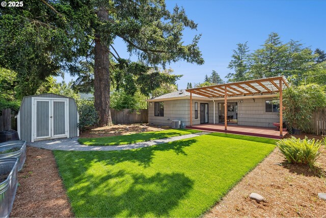 rear view of property with a deck, a storage unit, an outdoor structure, and central AC