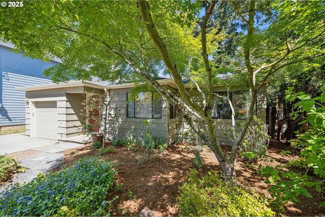 view of front of home with a garage and concrete driveway