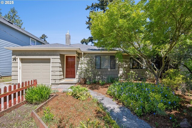 ranch-style house with a garage, a chimney, and fence