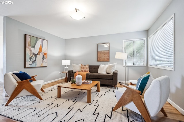 living room featuring baseboards and light wood finished floors