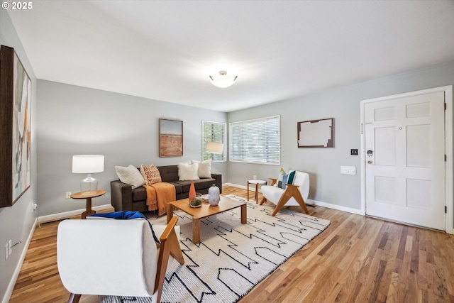living area featuring light wood-type flooring and baseboards