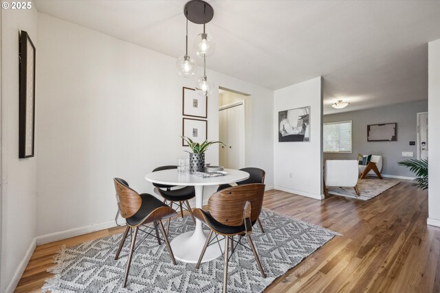 dining area with wood finished floors and baseboards