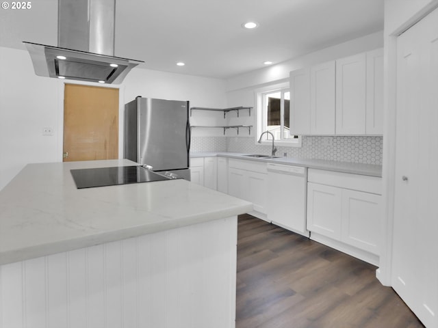 kitchen with open shelves, freestanding refrigerator, a sink, island range hood, and dishwasher