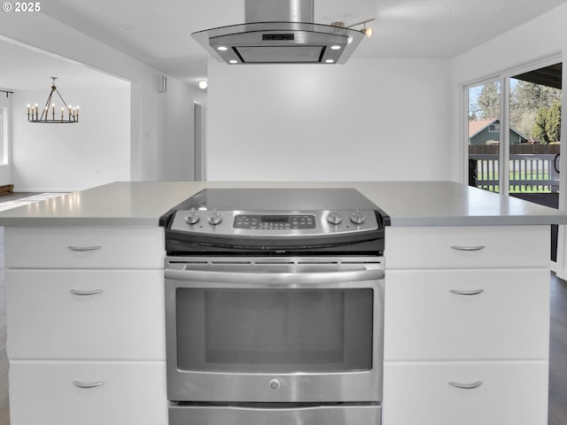 kitchen with stainless steel electric range oven, light countertops, white cabinetry, and island range hood