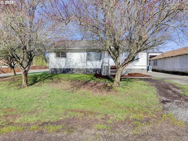 view of front of property featuring crawl space, fence, central AC, and a front yard