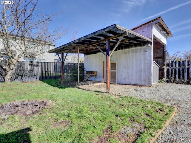 exterior space featuring an outbuilding and fence