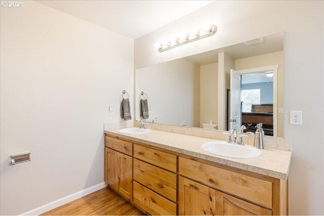 21600 NE Forest Dr, Yamhill, OR 97148 - bathroom featuring double vanity, toilet, wood finished floors, and baseboards