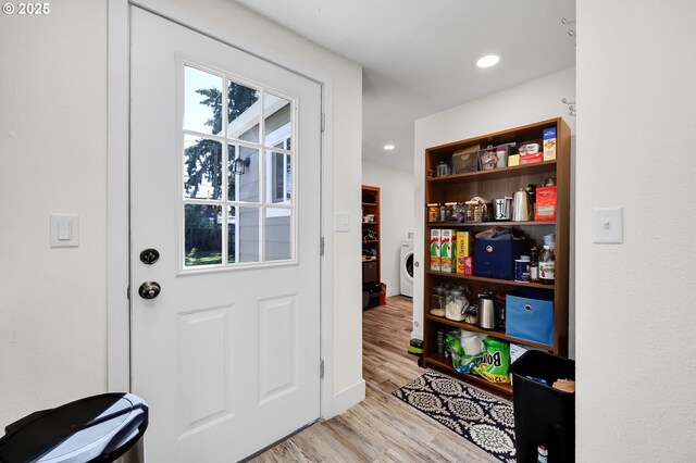 entryway featuring light wood-type flooring, washer / clothes dryer, recessed lighting, and baseboards