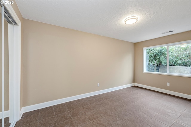 empty room featuring a textured ceiling