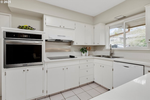 kitchen featuring sink, white dishwasher, white cabinets, black electric cooktop, and oven