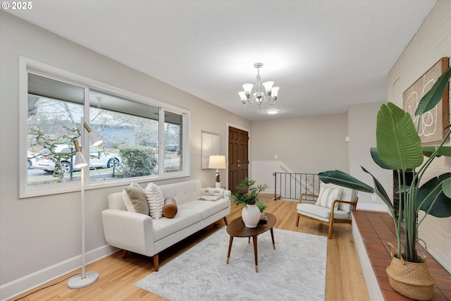 living room featuring an inviting chandelier and light hardwood / wood-style flooring