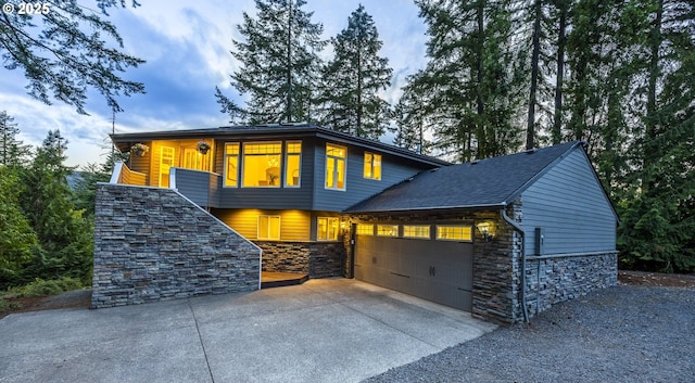 32518 Dillard Rd, Eugene, OR 97405 - view of front facade featuring stone siding, an attached garage, and driveway