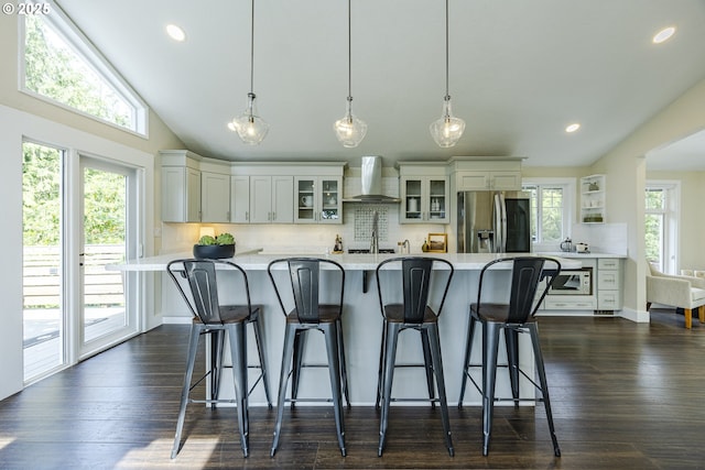 32518 Dillard Rd, Eugene, OR 97405 - kitchen featuring stainless steel fridge with ice dispenser, wall chimney exhaust hood, light countertops, tasteful backsplash, and lofted ceiling