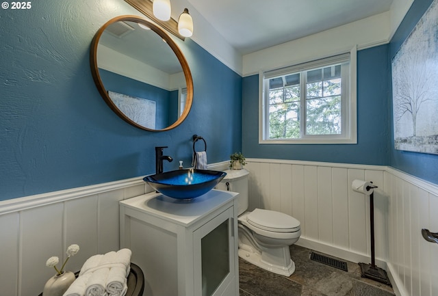 32518 Dillard Rd, Eugene, OR 97405 - half bathroom featuring wainscoting, vanity, and stone finish flooring