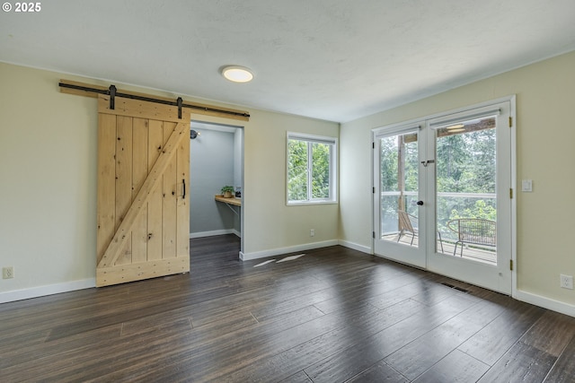 32518 Dillard Rd, Eugene, OR 97405 - unfurnished room featuring a barn door and dark wood-style floors