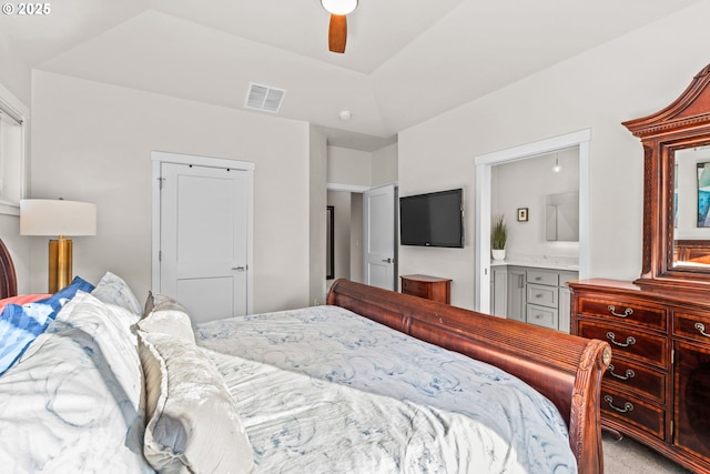 carpeted bedroom with ceiling fan, ensuite bath, and lofted ceiling